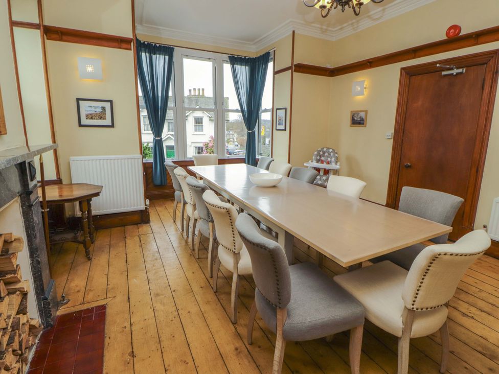 A dining room with a long table and chairs at 1 Park Road in Windermere