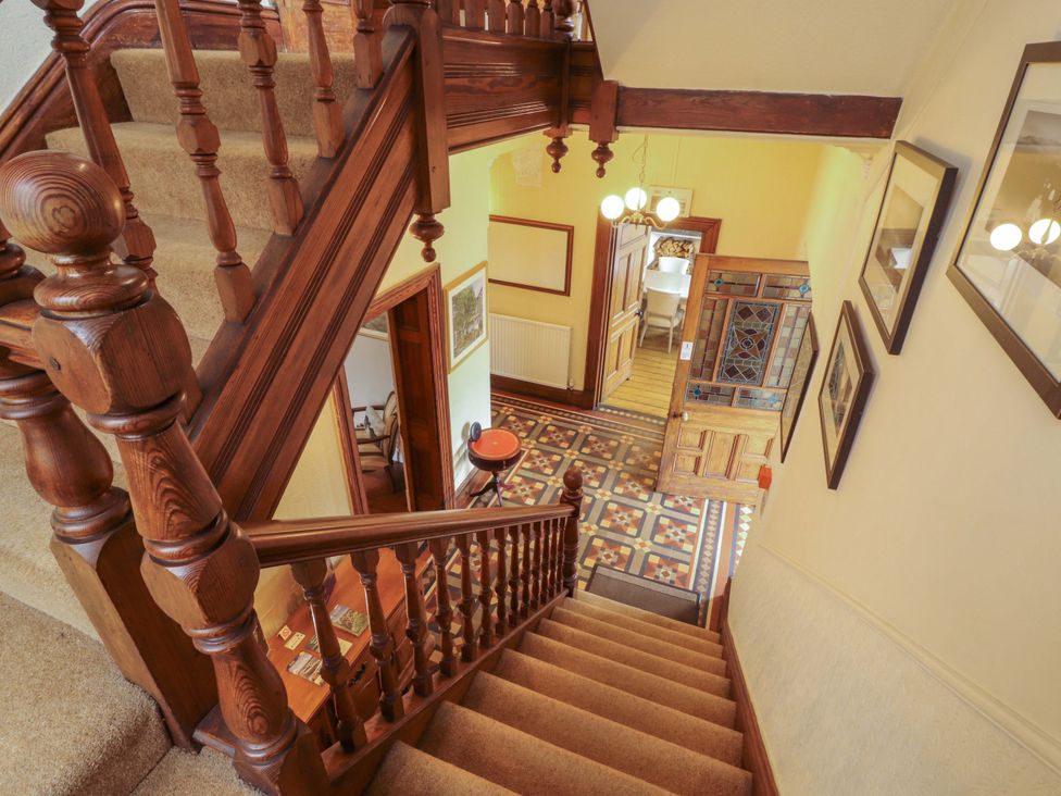 A staircase and hallway with patterned flooring at 1 Park Road Windermere