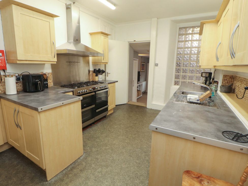 A kitchen with cabinets, oven, stove, and sink at 1 Park Road Windermere