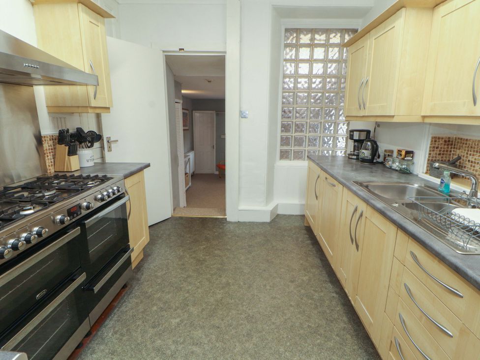 A kitchen with cabinets and appliances at 1 Park Road Windermere