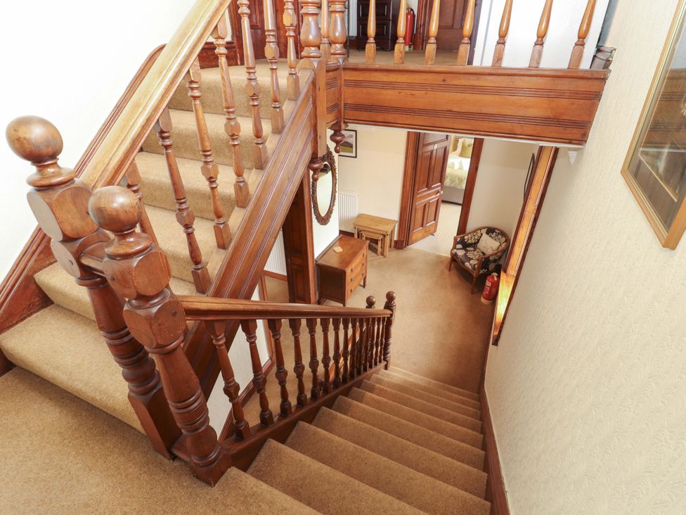 A staircase and hallway with furniture at 1 Park Road in Windermere