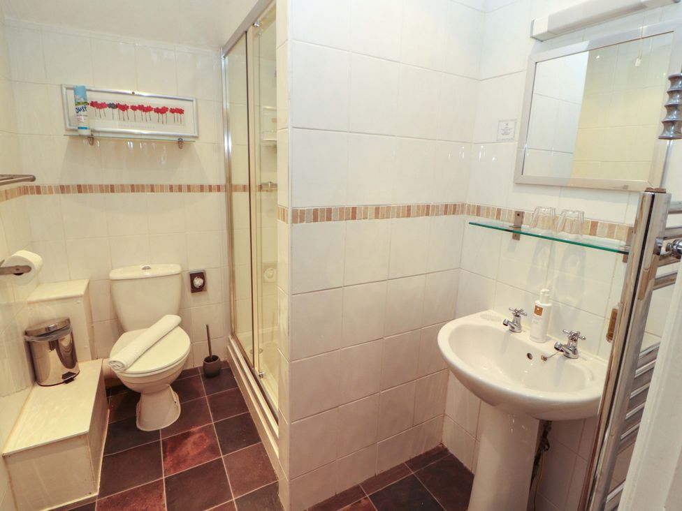 A bathroom with a shower, toilet, and sink at 1 Park Road Windermere