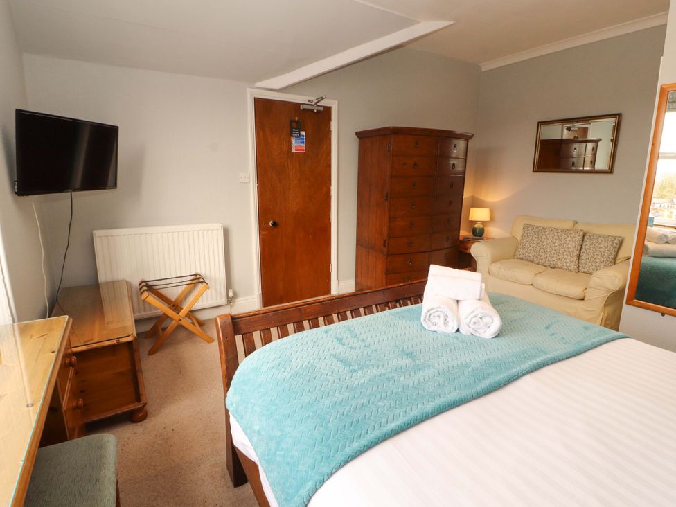 A bedroom with a bed and television at 1 Park Road in Windermere