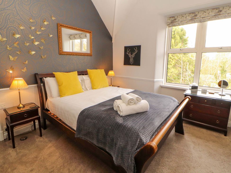 A bedroom with a bed and dresser at 1 Park Road Windermere
