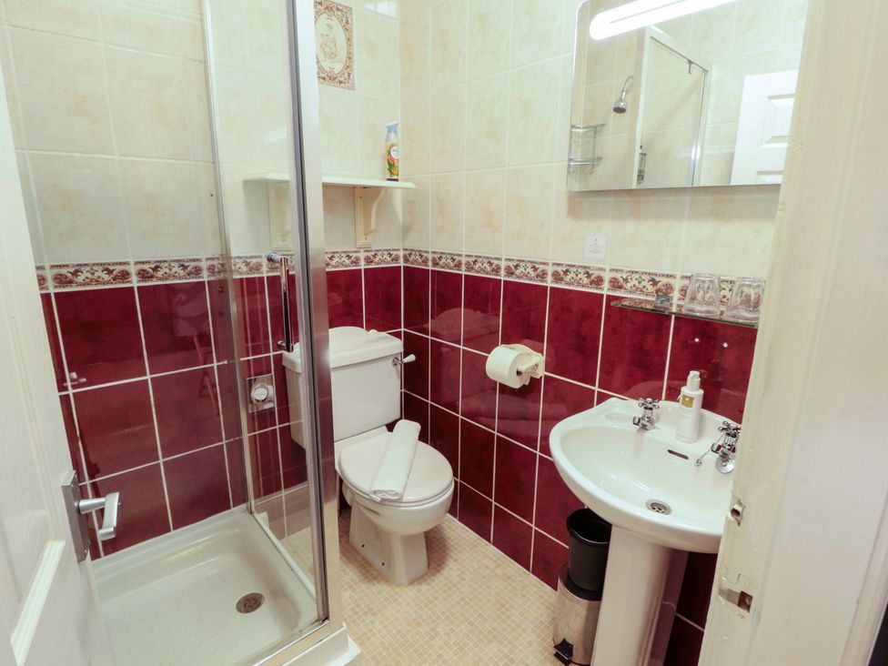 A bathroom with a shower and sink at 1 Park Road in Windermere