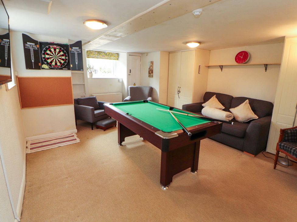 A games room with a pool table and dartboard at 1 Park Road in Windermere