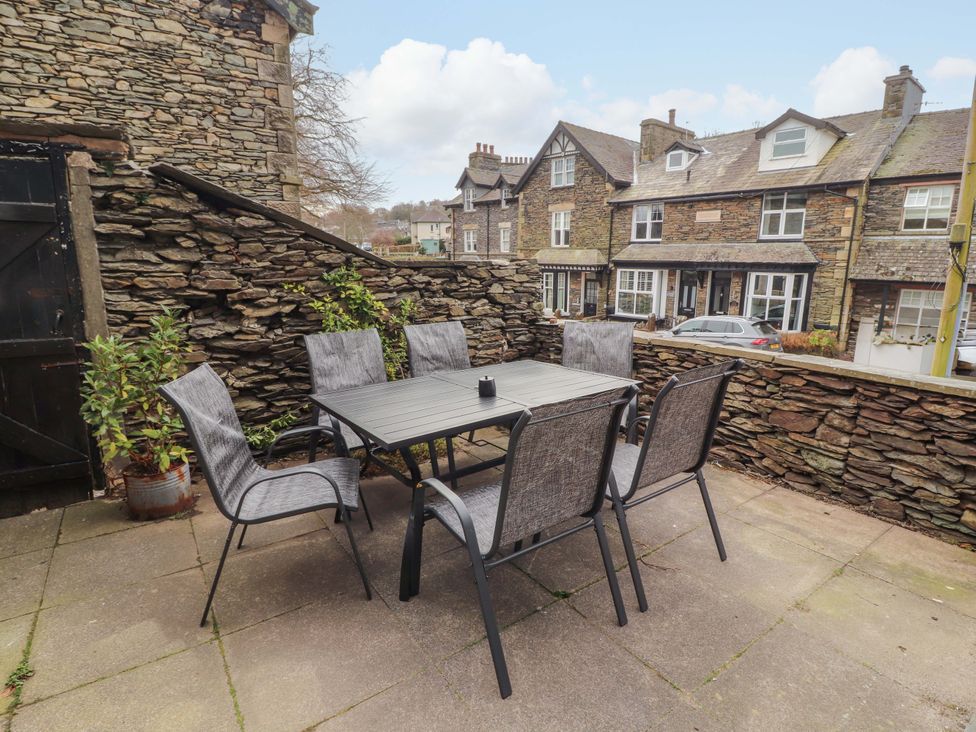 An outdoor seating area with a table and chairs at 1 Park Road Windermere