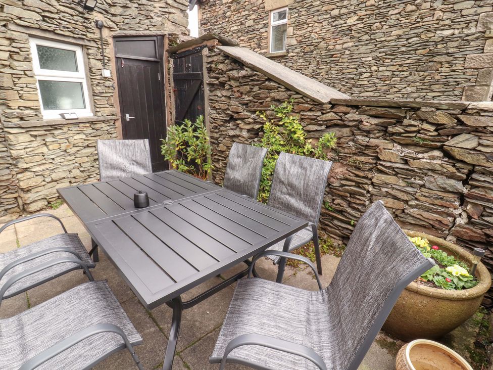 An outdoor area with a table and chairs at 1 Park Road Windermere