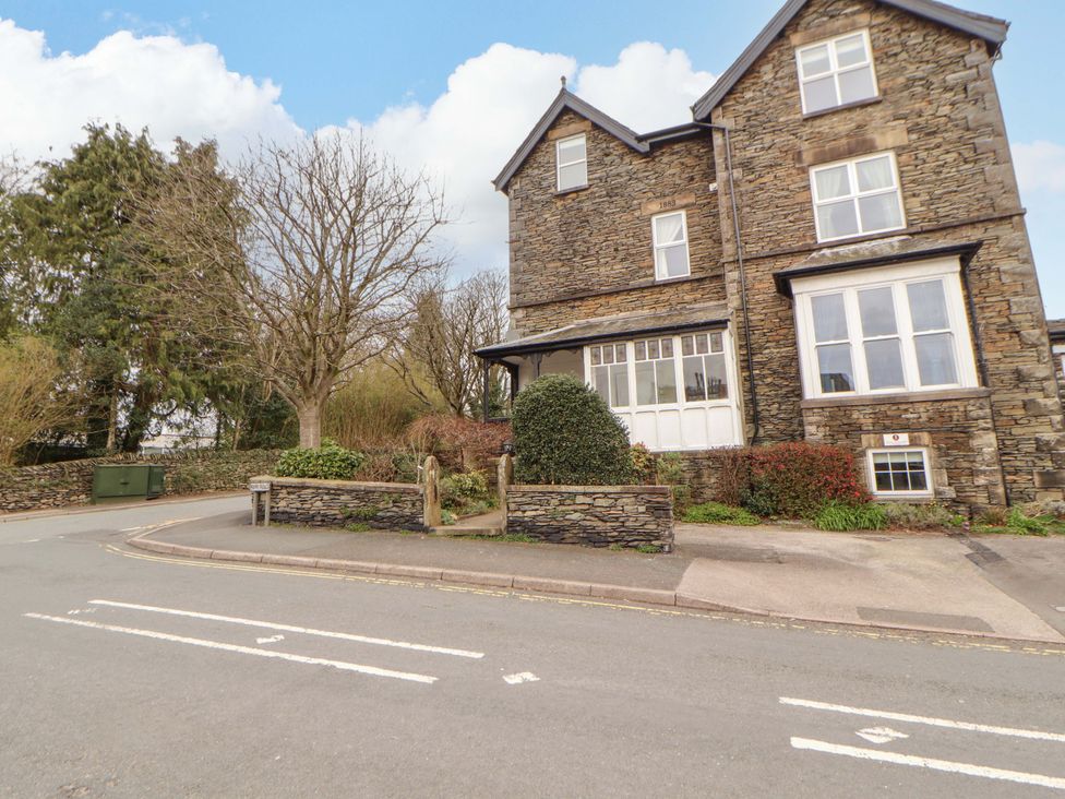 A stone building with a path and greenery at 1 Park Road in Windermere
