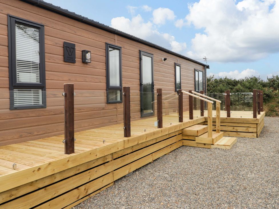 A building with a wooden deck and steps at Dolphin in Haverfordwest