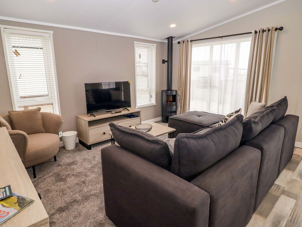 A living room with a sofa and television at Dolphin in Haverfordwest