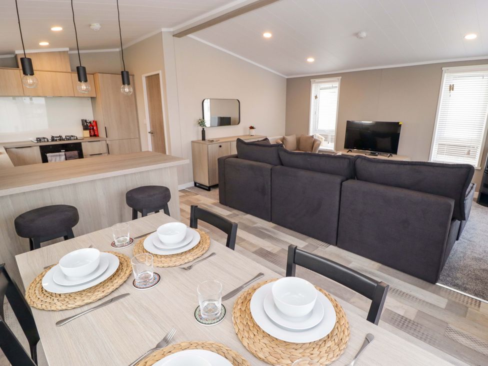 A living room and dining area with a kitchen at Dolphin in Haverfordwest