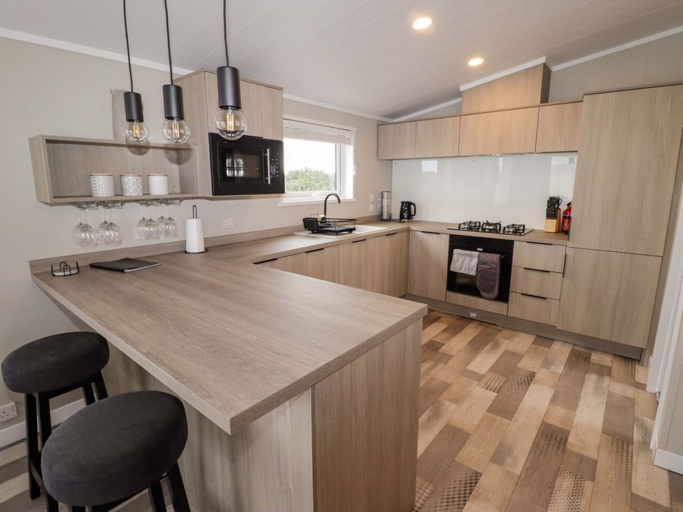 A kitchen with countertops and stools at Dolphin in Haverfordwest