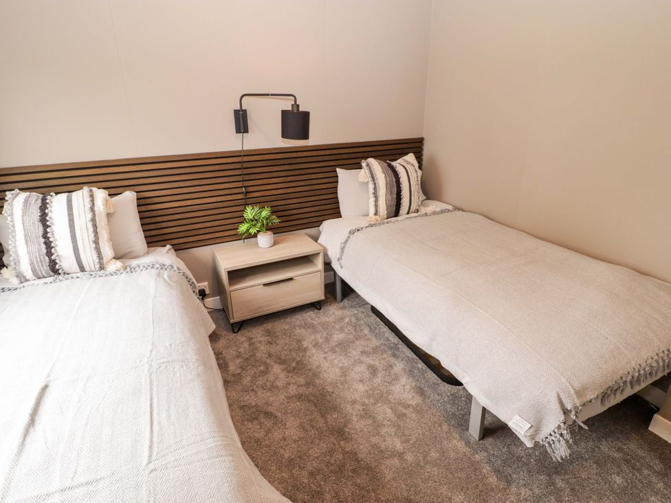 A bedroom with two beds and a nightstand at Dolphin Haverfordwest