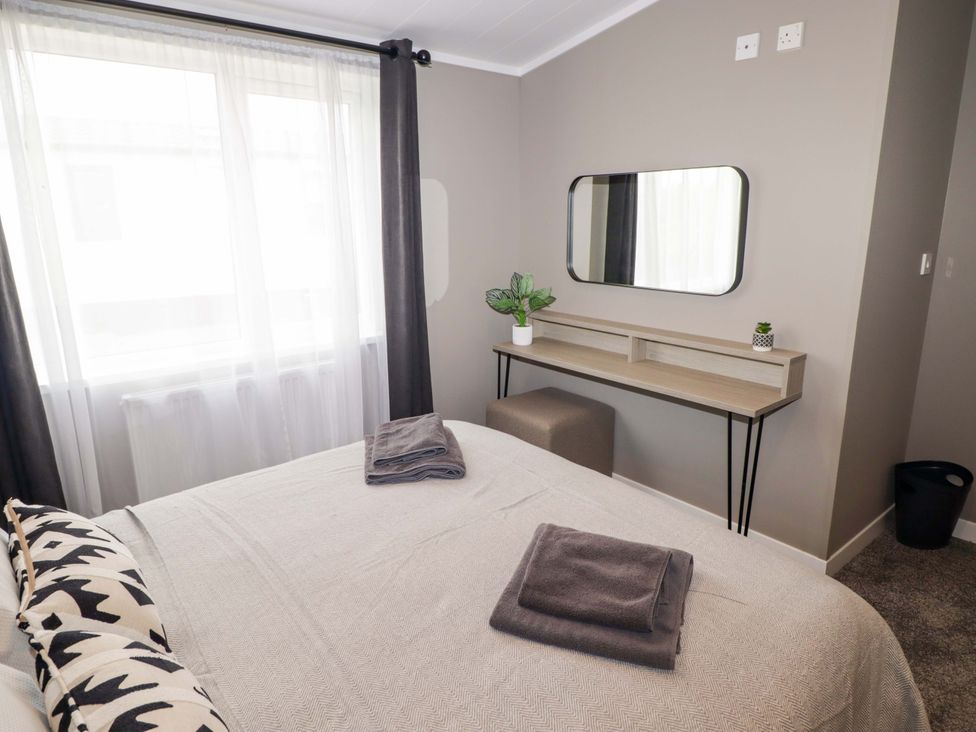 A bedroom with a bed and desk at Dolphin in Haverfordwest