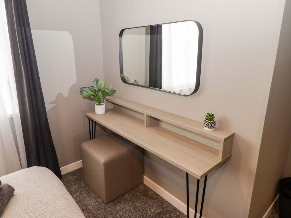 A bedroom with a desk and mirror at Dolphin Haverfordwest