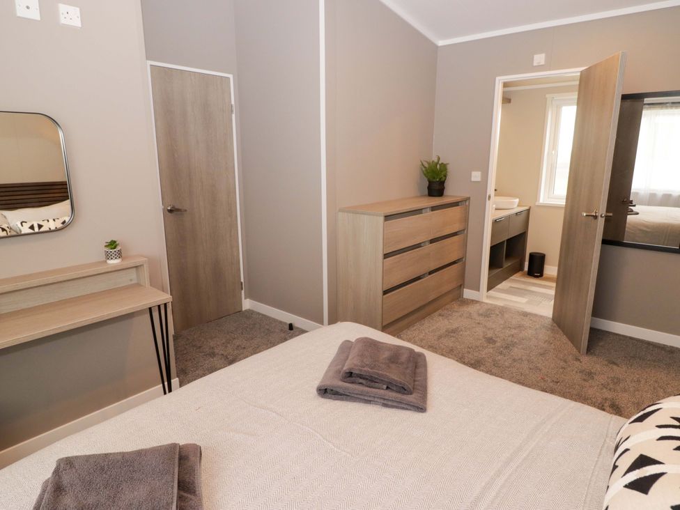 A bedroom with a bed and dresser at Dolphin in Haverfordwest