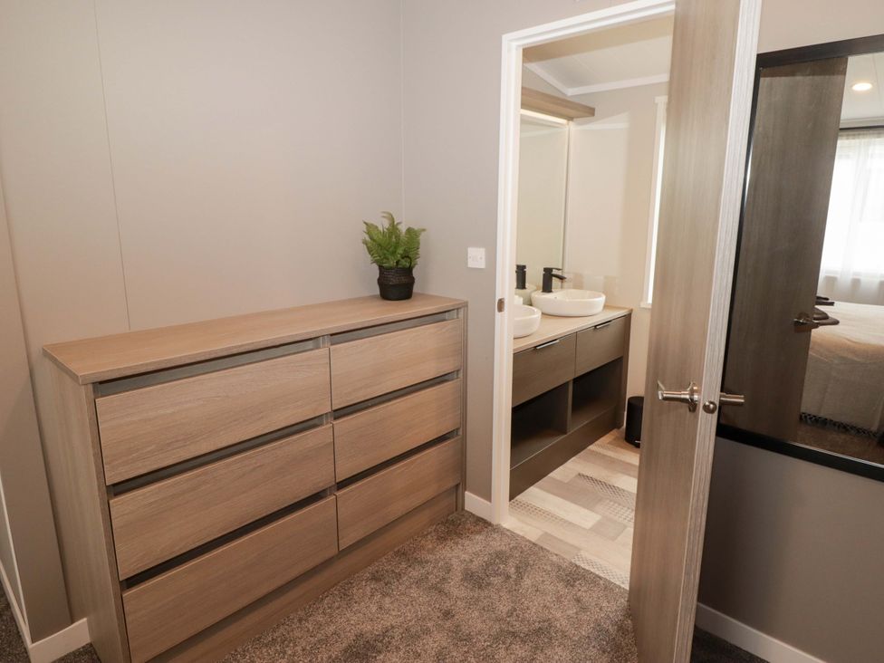 A bathroom with a dresser and sink at Dolphin in Haverfordwest