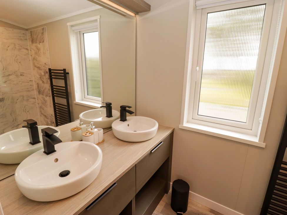 A bathroom with a double sink and mirror at Dolphin in Haverfordwest