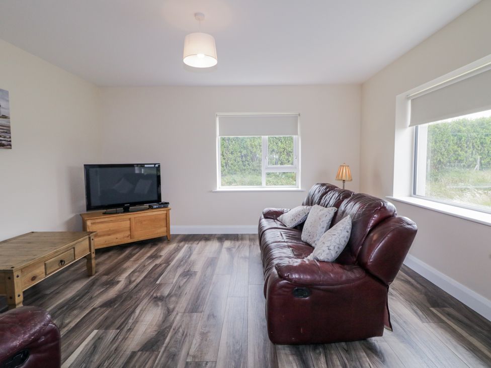 A living room with a sofa and television at teac Caoimhe Falcarragh