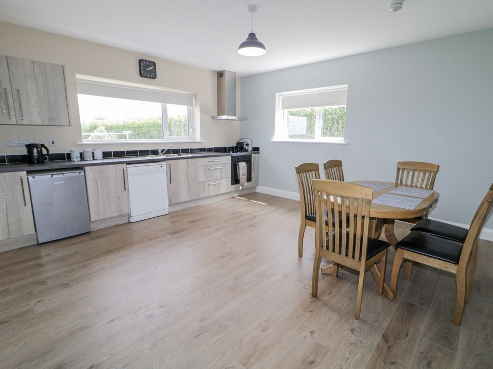 A kitchen with a table and chairs at Teac Caoimhe in Falcarragh