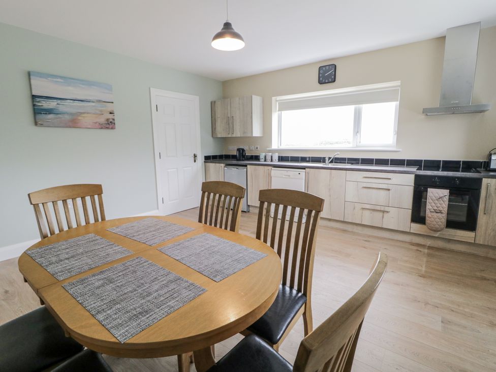 A kitchen with a table and chairs at Teac Caoimhe in Falcarragh