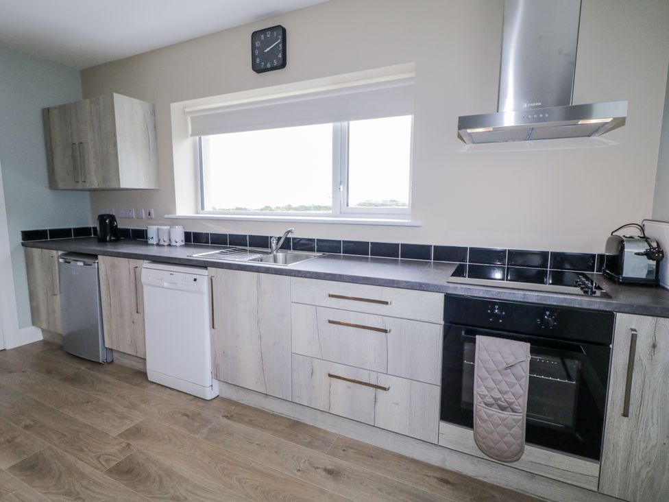 A kitchen with cabinets and appliances at Teac Caoimhe in Falcarragh