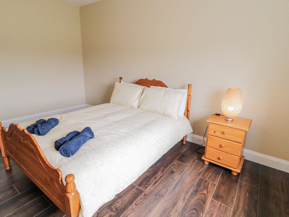 A bedroom with a bed and nightstand at Teac Caoimhe, Falcarragh