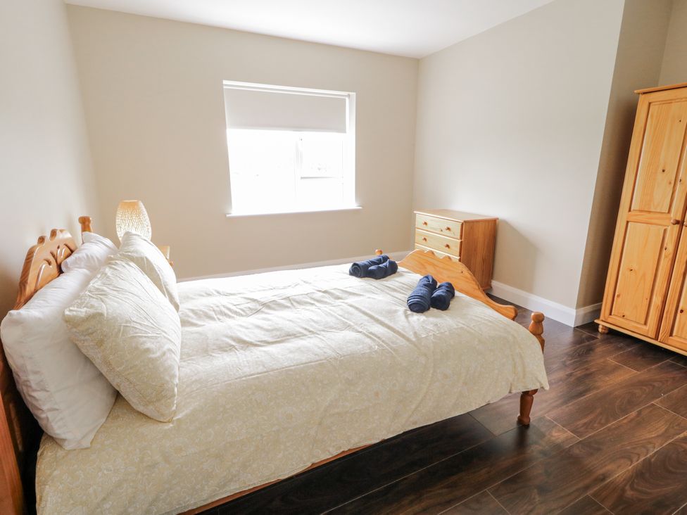 A bedroom with a bed and dresser at Teac Caoimhe in Falcarragh