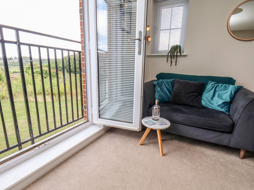 A living room with a sofa and table at Larpool Retreat