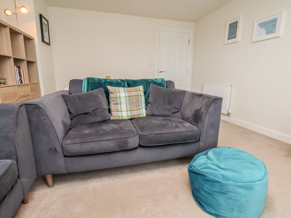 A living room with a sofa and bean bag at Larpool Retreat