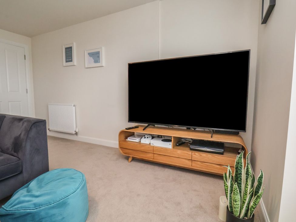 A living room with a television and media console at Larpool Retreat 