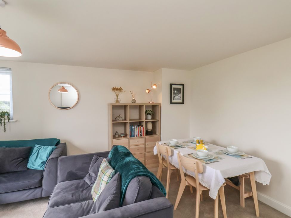 A dining room with a table and chairs at Larpool Retreat 