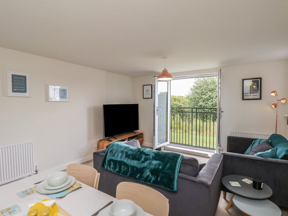 A living room with a sofa and a television at Larpool Retreat