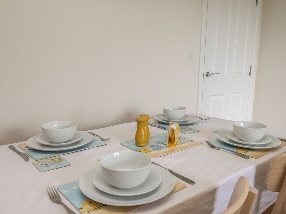 A dining table set with bowls and cutlery at Larpool Retreat