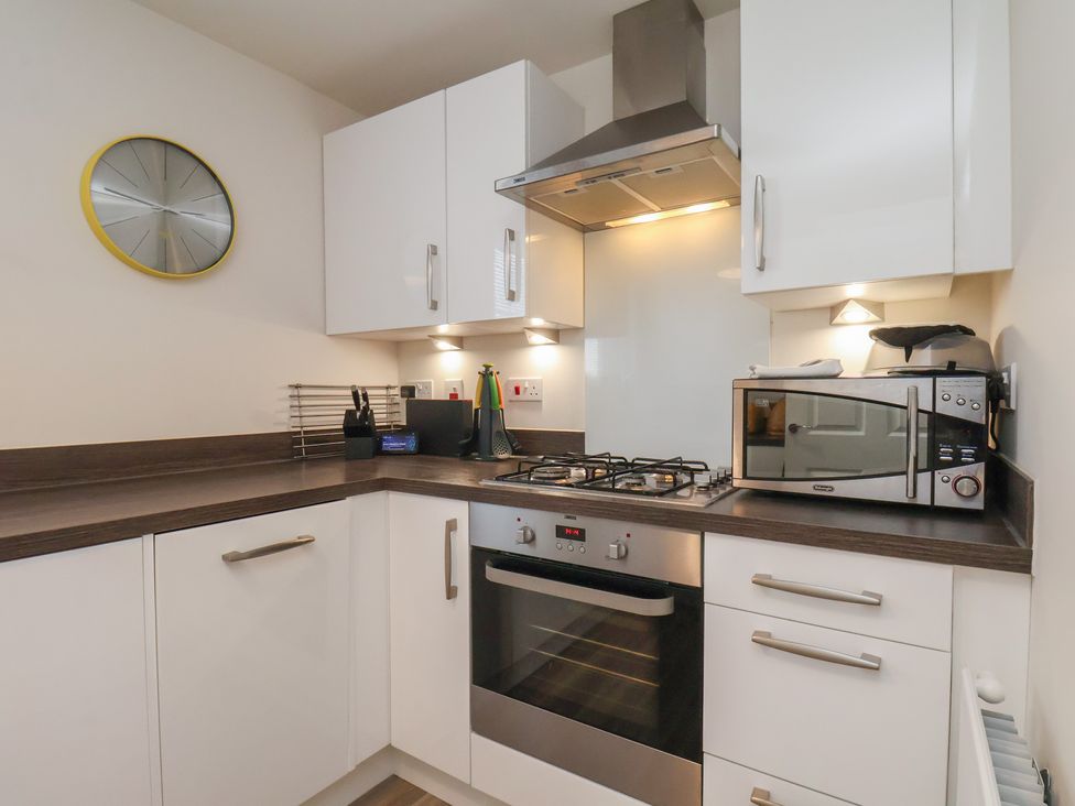 A kitchen with a cooktop and microwave at Larpool Retreat
