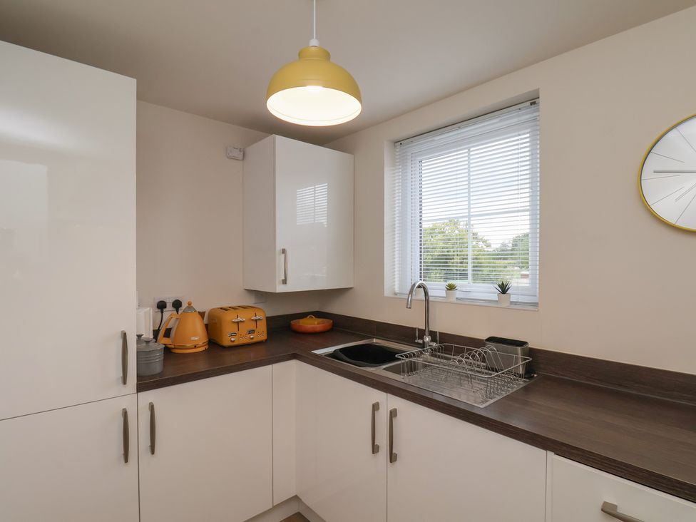 A kitchen with sink and appliances at Larpool Retreat