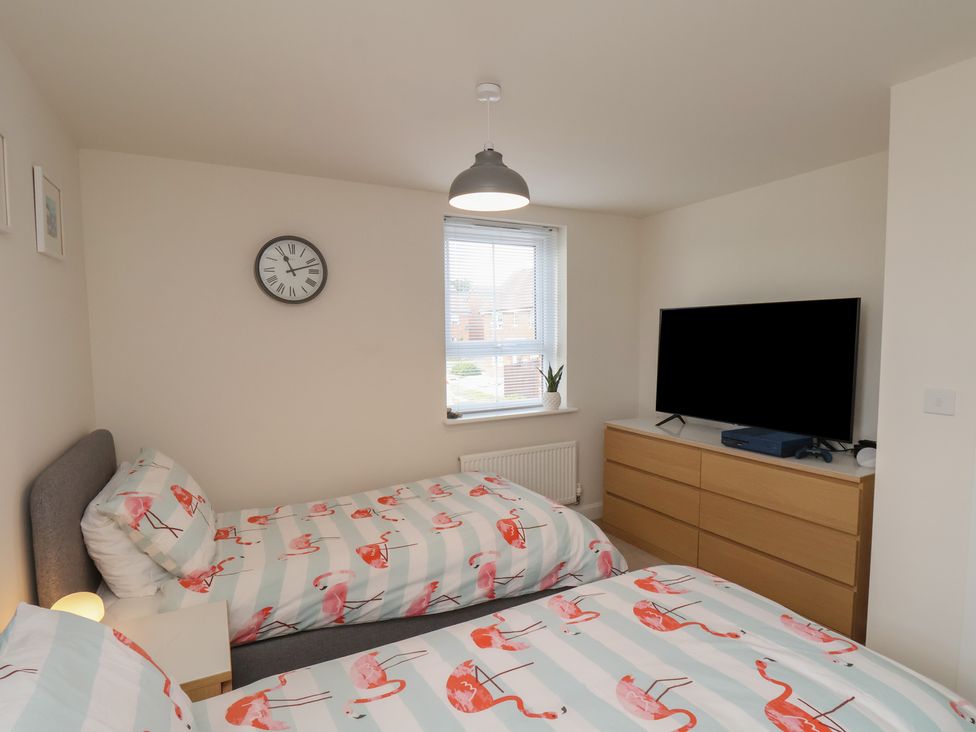 A bedroom with two beds and a television at Larpool Retreat in 