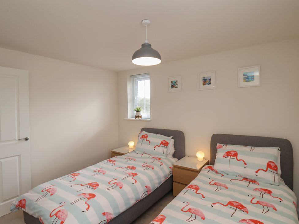 A bedroom with two beds and a window at Larpool Retreat 