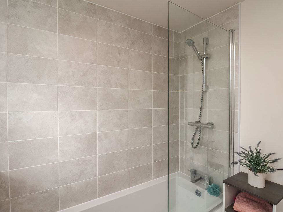 A bathroom with a shower and bathtub at Larpool Retreat