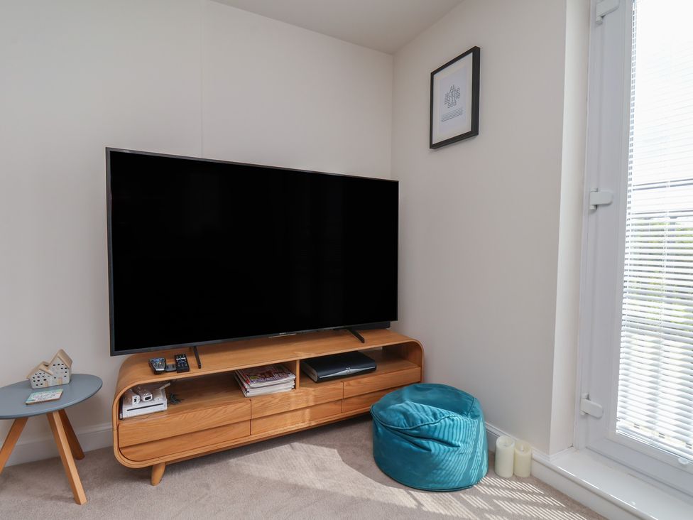 A living room with a television and media console at Larpool Retreat in Whitby
