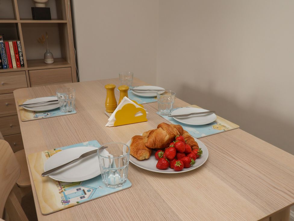 A dining table set with plates and food at Larpool Retreat in Whitby