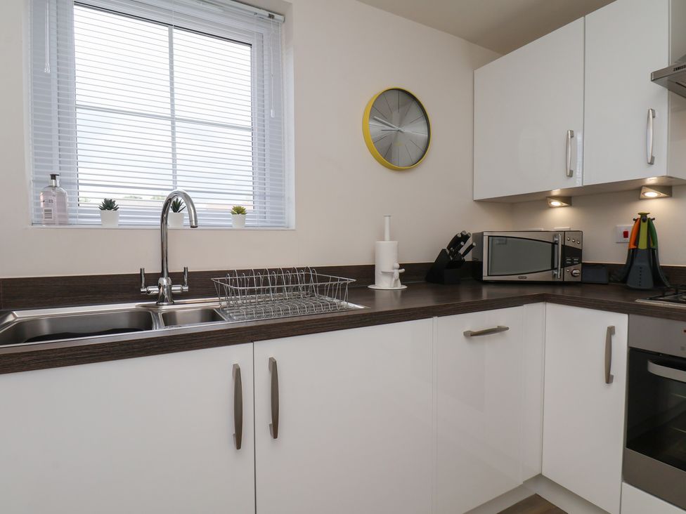 A kitchen with a sink and microwave at Larpool Retreat in Whitby