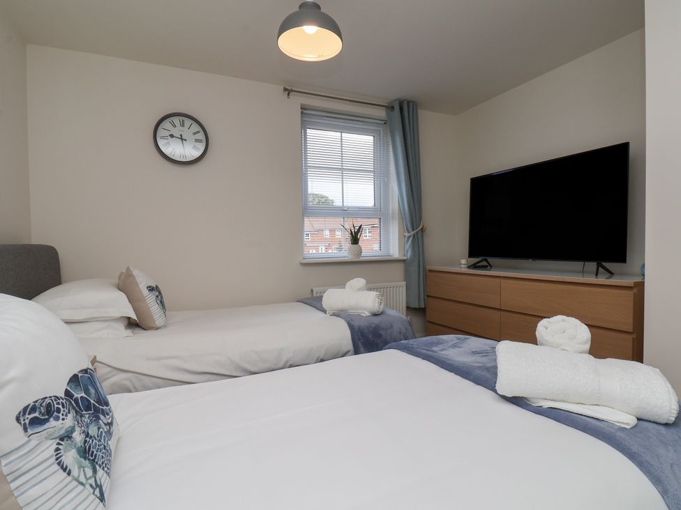 A bedroom with two beds and a television at Larpool Retreat in Whitby