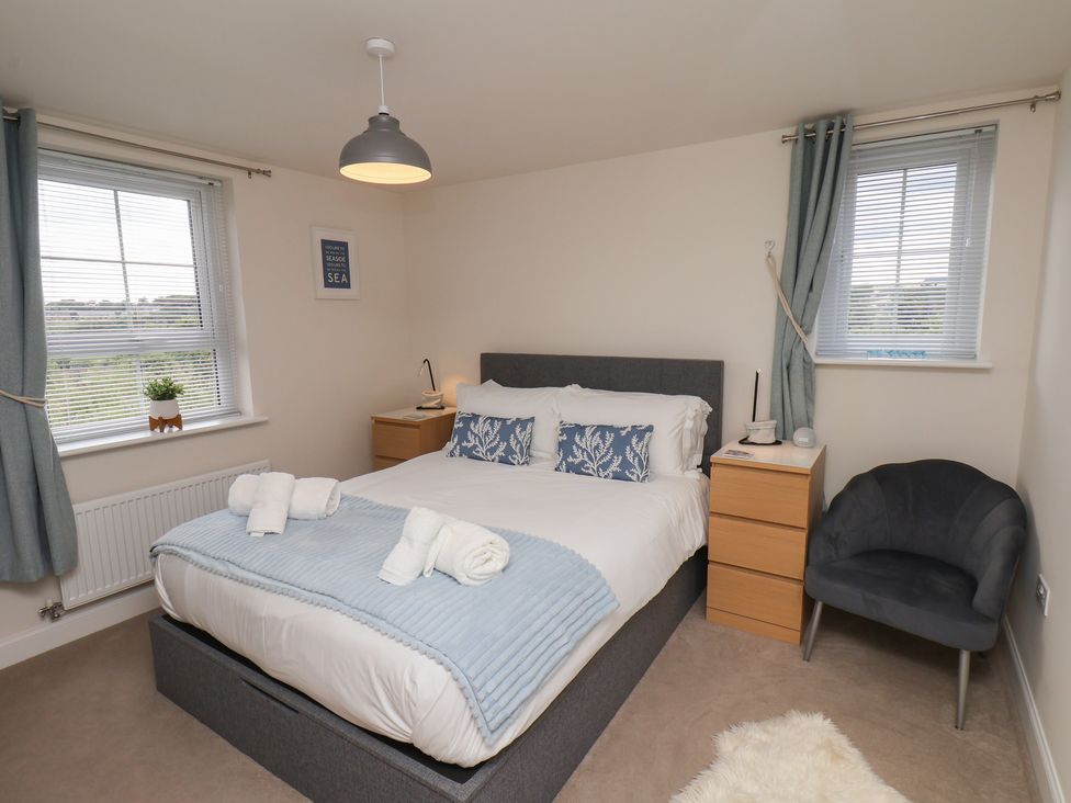 A bedroom with a bed and bedside table at Larpool Retreat in Whitby