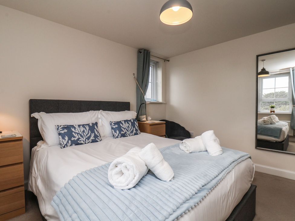 A bedroom with a bed and bedside table at Larpool Retreat in Whitby