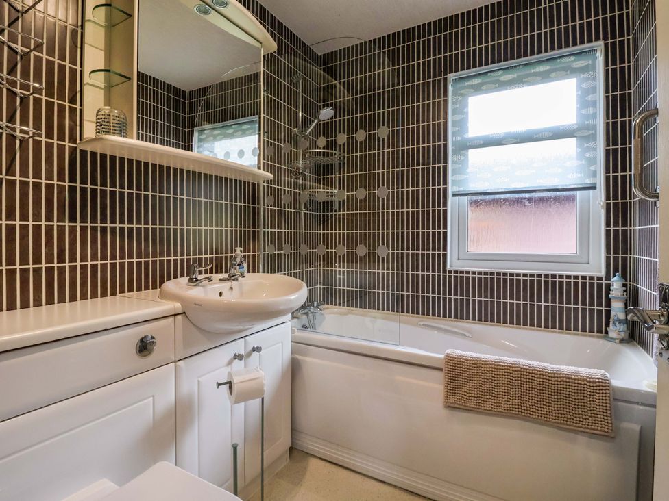 A bathroom with a sink and bath tub at Badgers Retreat - Two Dales Richmond