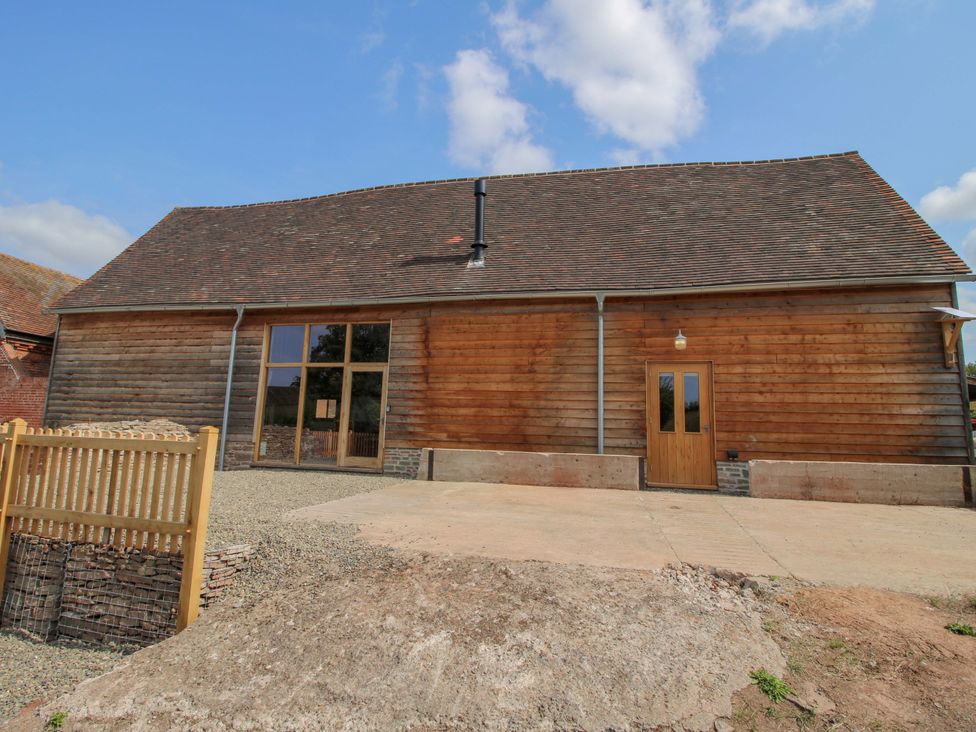 An exterior view of a wooden barn at Crook Barn in Tenbury Wells