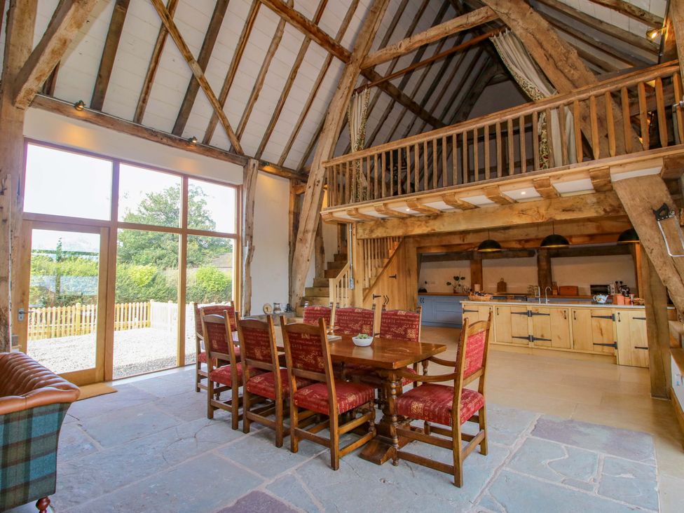 A dining area with a table and chairs at Crook Barn in Tenbury Wells