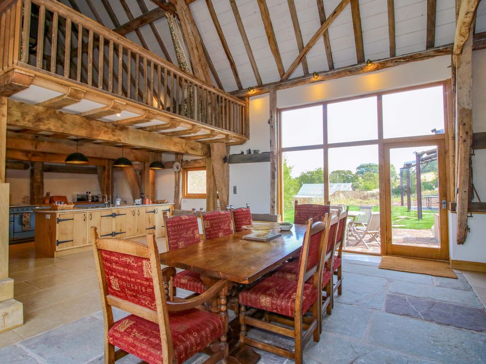 A dining room with a large table and chairs at Crook Barn, Tenbury Wells